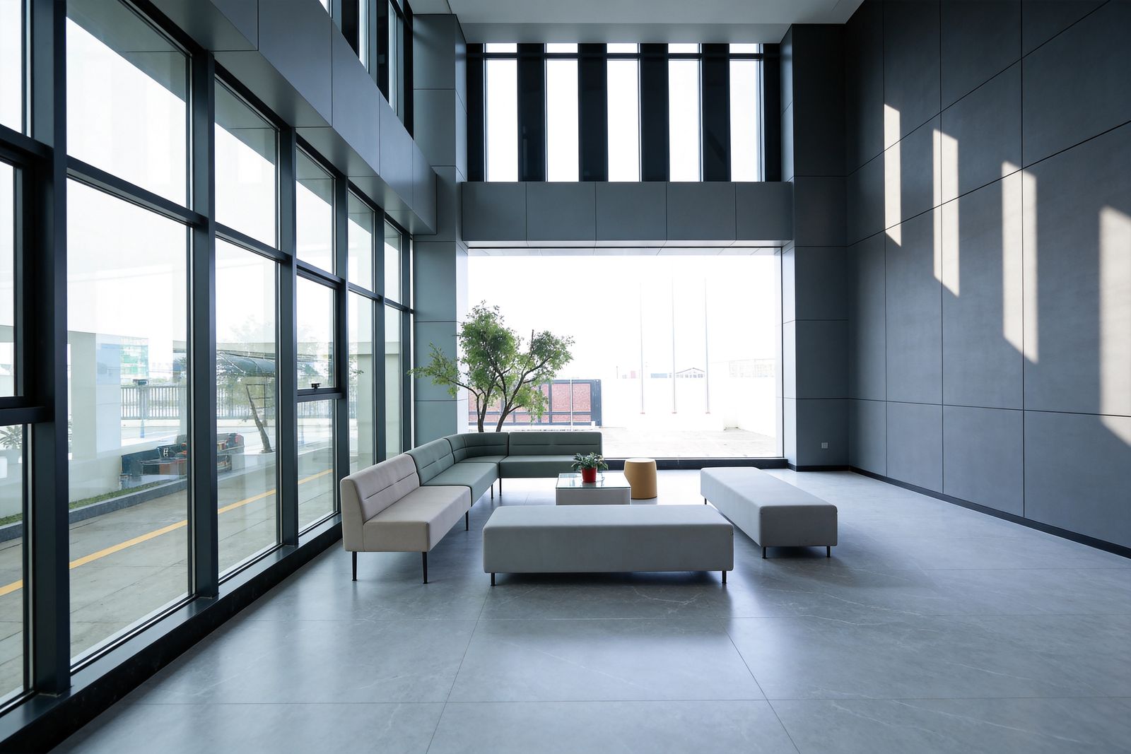 Double height atrium with dark framed glazing